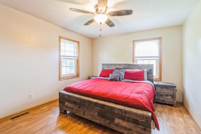 794 SE 61st St, Pleasant Hill, IA 50327 - bedroom featuring wood finished floors, baseboards, and a ceiling fan