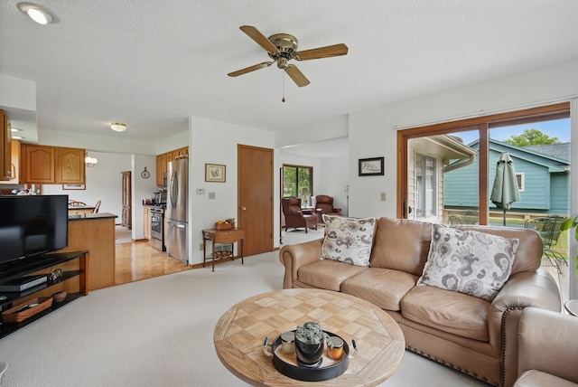 1011 NE 60th Ave, Des Moines, IA 50313 - living room featuring ceiling fan and light carpet