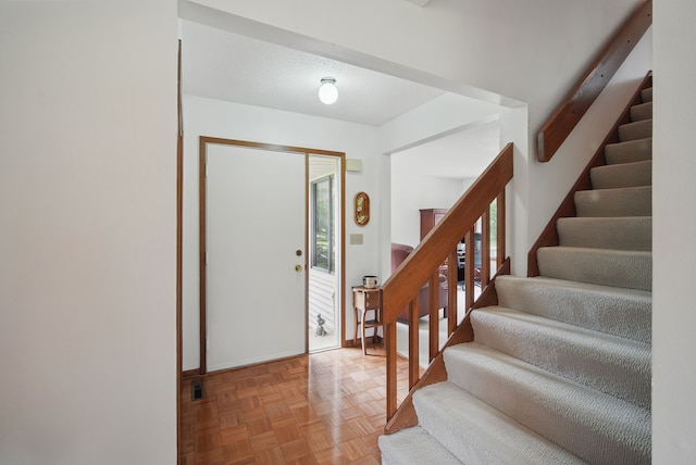 1011 NE 60th Ave, Des Moines, IA 50313 - foyer entrance featuring stairs and baseboards
