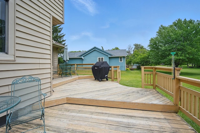 1011 NE 60th Ave, Des Moines, IA 50313 - wooden terrace with a grill, a lawn, and outdoor dining area
