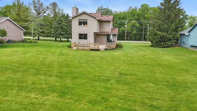 1011 NE 60th Ave, Des Moines, IA 50313 - view of grassy yard with a deck