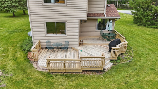 1011 NE 60th Ave, Des Moines, IA 50313 - wooden terrace with a lawn, a grill, and outdoor dining space