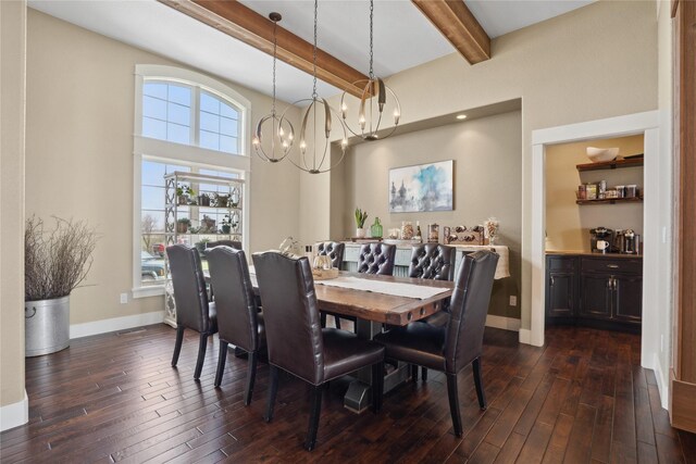 2492 55th St, Vinton, IA 52349 - dining space with beam ceiling, dark wood-style flooring, baseboards, a chandelier, and a towering ceiling