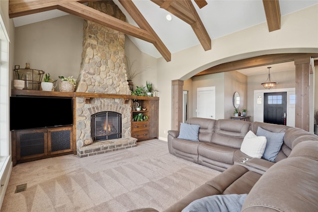 2492 55th St, Vinton, IA 52349 - carpeted living area with arched walkways, a fireplace, and baseboards