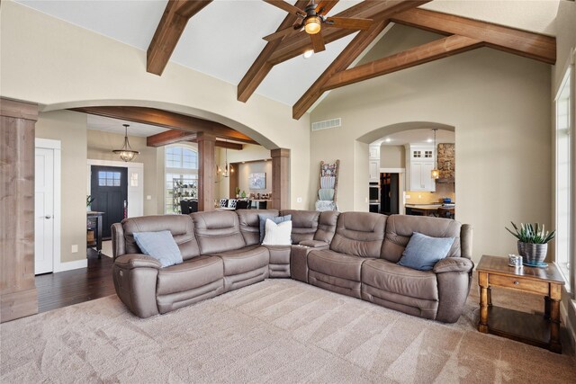 2492 55th St, Vinton, IA 52349 - carpeted living area with beam ceiling, arched walkways, ceiling fan, high vaulted ceiling, and baseboards