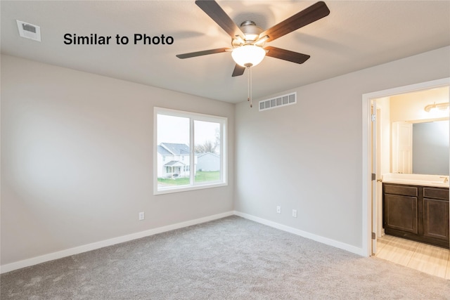 25087 Bluebird Cir, Adel, IA 50003 - unfurnished bedroom with light carpet, baseboards, ensuite bath, and ceiling fan
