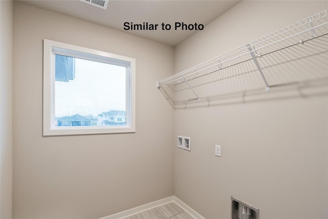 25087 Bluebird Cir, Adel, IA 50003 - washroom with washer hookup and baseboards