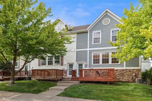 15203 Greenbelt Dr, Urbandale, IA 50323 - townhome / multi-family property featuring a front yard, a deck, central AC unit, stone siding, and a shingled roof