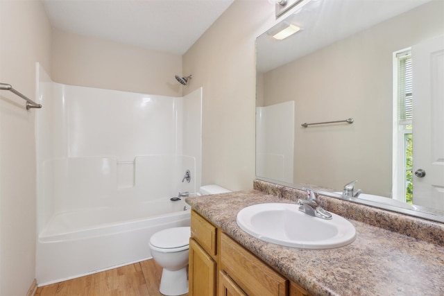15203 Greenbelt Dr, Urbandale, IA 50323 - bathroom featuring toilet, vanity, wood finished floors, and bathtub / shower combination