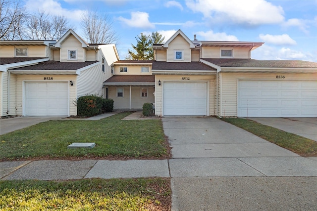 8532 Oakwood Dr, Urbandale, IA 50322 - townhome / multi-family property featuring a front lawn and concrete driveway