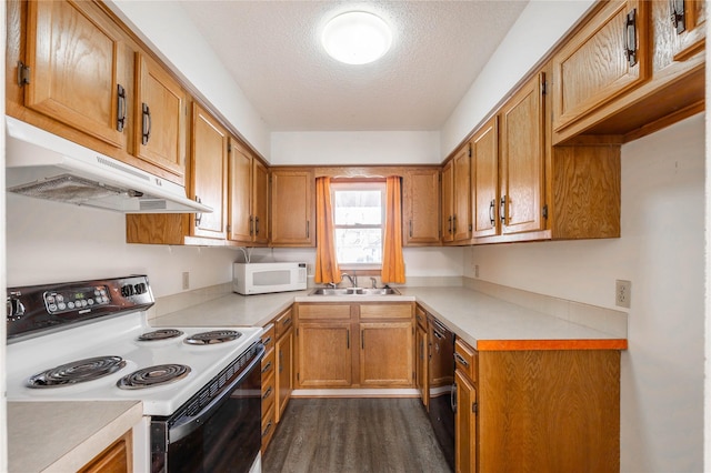 8532 Oakwood Dr, Urbandale, IA 50322 - kitchen featuring white appliances, under cabinet range hood, a sink, light countertops, and a textured ceiling