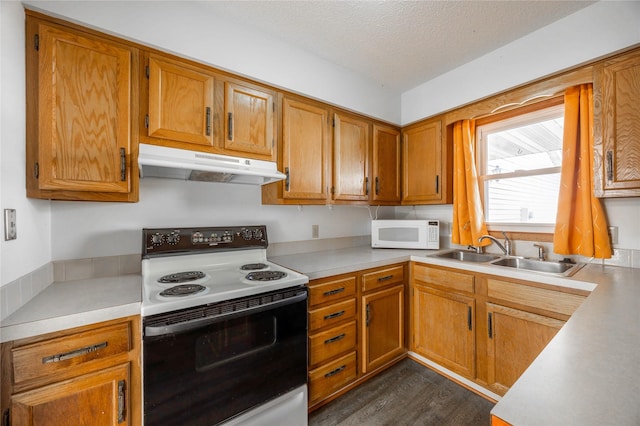 8532 Oakwood Dr, Urbandale, IA 50322 - kitchen featuring under cabinet range hood, white appliances, a sink, light countertops, and a textured ceiling