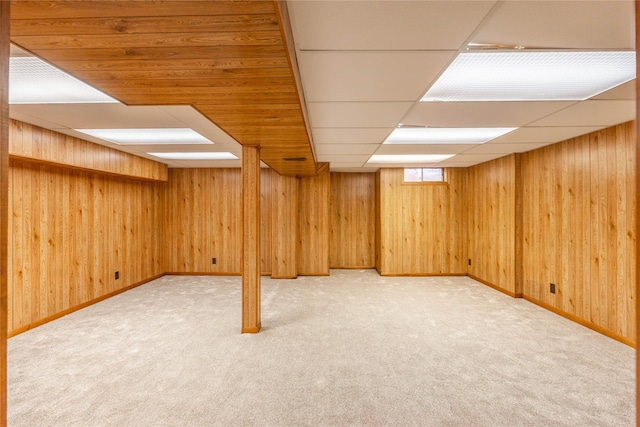 8532 Oakwood Dr, Urbandale, IA 50322 - below grade area featuring carpet, wooden walls, baseboards, and a drop ceiling