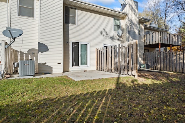 8532 Oakwood Dr, Urbandale, IA 50322 - rear view of property featuring central air condition unit, a patio area, and a chimney