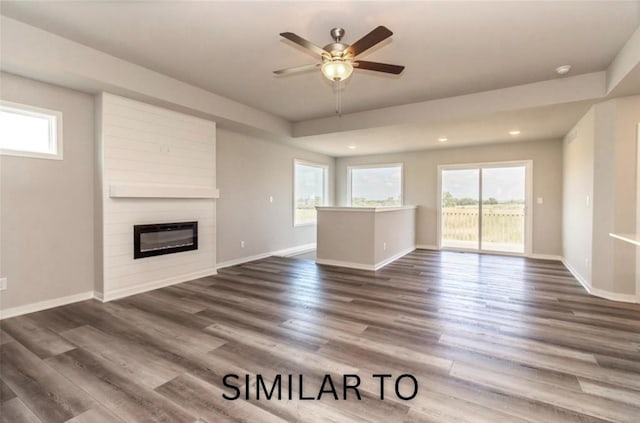 926 Willow Valley Dr, Norwalk, IA 50211 - unfurnished living room featuring plenty of natural light, a ceiling fan, a large fireplace, baseboards, and recessed lighting