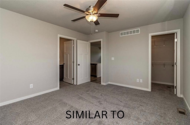926 Willow Valley Dr, Norwalk, IA 50211 - unfurnished bedroom with carpet, baseboards, a walk in closet, and a closet