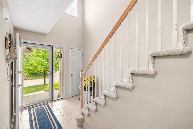 9812 Green View Ln, Johnston, IA 50131 - entryway with stairway, a high ceiling, and tile patterned floors