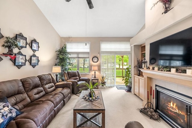 9812 Green View Ln, Johnston, IA 50131 - living area with carpet floors, a tile fireplace, high vaulted ceiling, and a ceiling fan