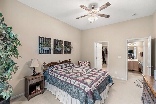 9812 Green View Ln, Johnston, IA 50131 - bedroom featuring light carpet, a walk in closet, ensuite bathroom, and ceiling fan