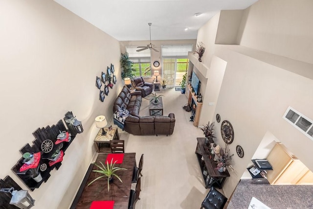 9812 Green View Ln, Johnston, IA 50131 - carpeted living area featuring a fireplace and a ceiling fan