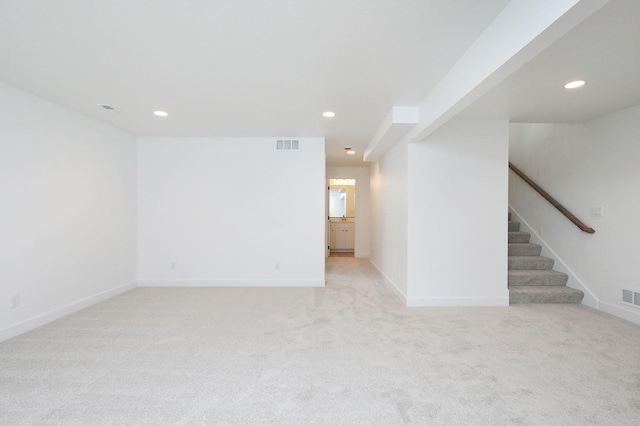 2500 NE 6th St, Grimes, IA 50111 - unfurnished living room featuring recessed lighting, light carpet, stairs, and baseboards