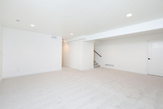 2500 NE 6th St, Grimes, IA 50111 - finished basement with stairway, recessed lighting, light carpet, and baseboards