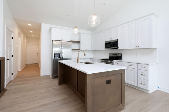 2500 NE 6th St, Grimes, IA 50111 - kitchen featuring a sink, stainless steel appliances, light wood-type flooring, white cabinets, and recessed lighting