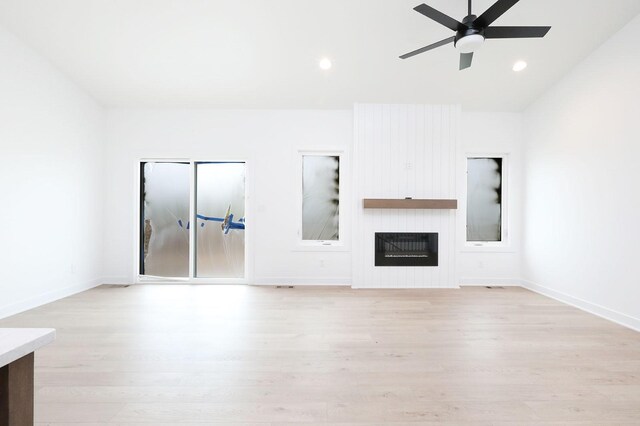 2500 NE 6th St, Grimes, IA 50111 - unfurnished living room featuring light wood-style flooring, ceiling fan, baseboards, and recessed lighting