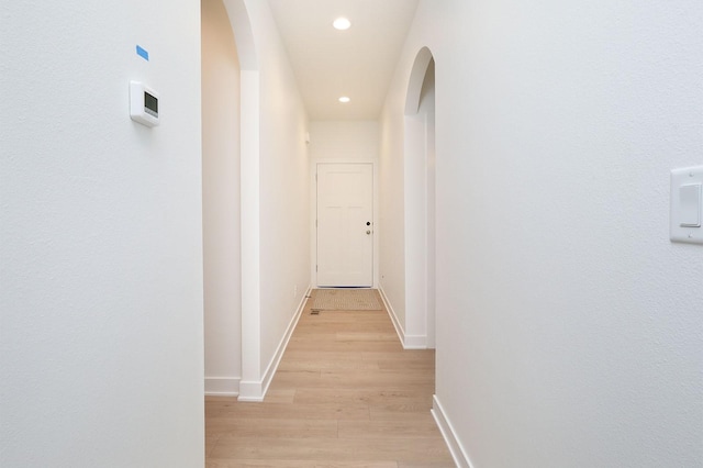 2500 NE 6th St, Grimes, IA 50111 - hallway featuring arched walkways, baseboards, light wood-type flooring, and recessed lighting