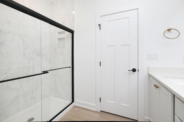 2500 NE 6th St, Grimes, IA 50111 - full bathroom featuring a shower stall, vanity, and wood finished floors