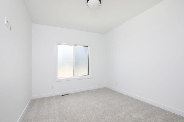 2500 NE 6th St, Grimes, IA 50111 - unfurnished room with light carpet and baseboards
