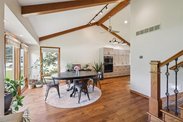 6935 NW 88th Ave, Johnston, IA 50131 - dining space featuring stairway, beamed ceiling, light wood-style flooring, high vaulted ceiling, and ceiling fan