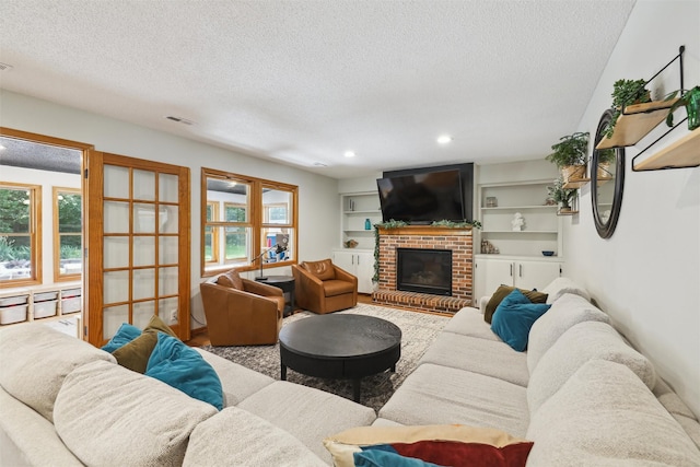 6935 NW 88th Ave, Johnston, IA 50131 - living area with a textured ceiling, a brick fireplace, and recessed lighting