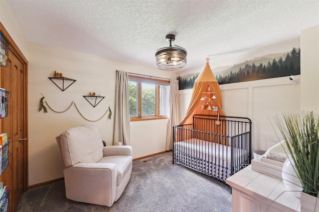 6935 NW 88th Ave, Johnston, IA 50131 - bedroom featuring carpet, a crib, baseboards, a textured ceiling, and a chandelier