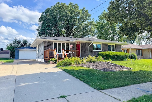 3223 Hull Ave, Des Moines, IA 50317 - ranch-style house with an outbuilding, a front yard, covered porch, and a garage