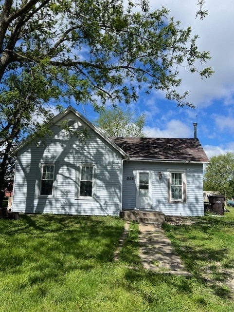 520 S Main St, Stuart, IA 50250 - rear view of property with a lawn