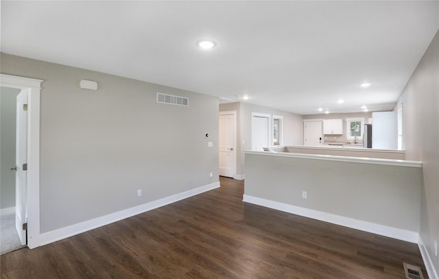 501 Kirkwood Ave, Des Moines, IA 50315 - unfurnished living room featuring recessed lighting, dark wood-style flooring, and baseboards