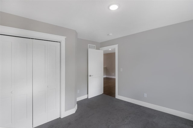 501 Kirkwood Ave, Des Moines, IA 50315 - unfurnished bedroom featuring dark colored carpet, baseboards, a closet, and recessed lighting