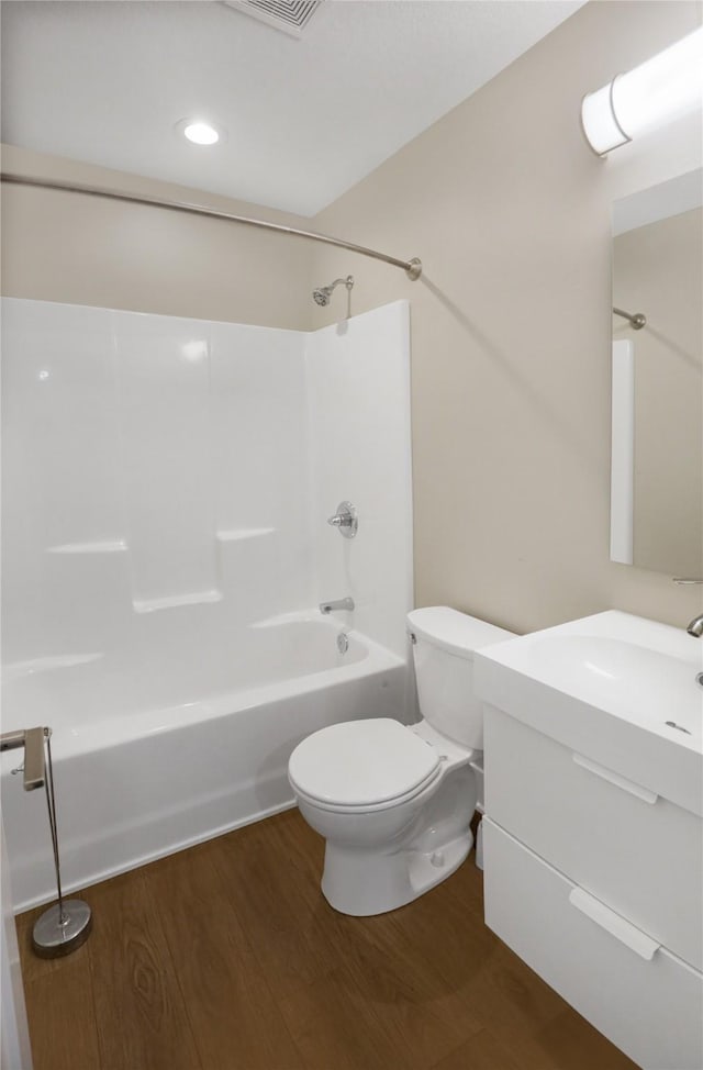 501 Kirkwood Ave, Des Moines, IA 50315 - bathroom featuring wood finished floors, vanity, toilet, and shower / tub combination