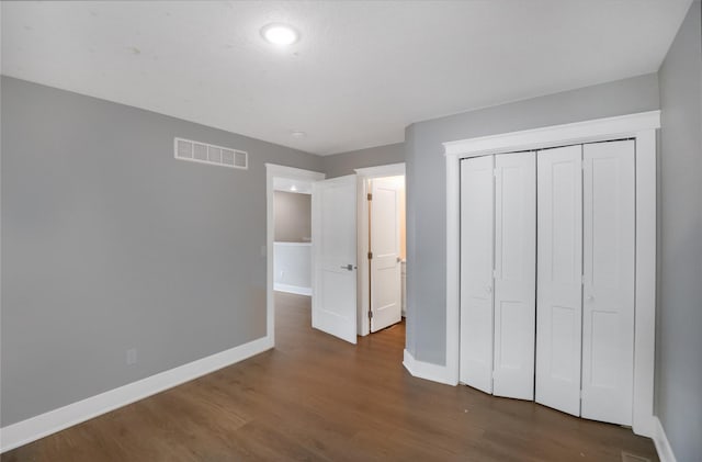 501 Kirkwood Ave, Des Moines, IA 50315 - unfurnished bedroom with baseboards, dark wood-type flooring, a closet, and recessed lighting