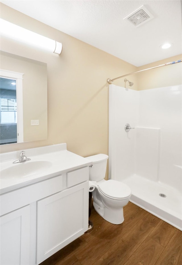 501 Kirkwood Ave, Des Moines, IA 50315 - bathroom with wood finished floors, vanity, a shower, and toilet