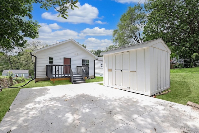 501 Kirkwood Ave, Des Moines, IA 50315 - view of front of home featuring board and batten siding, a patio area, a front yard, and a wooden deck
