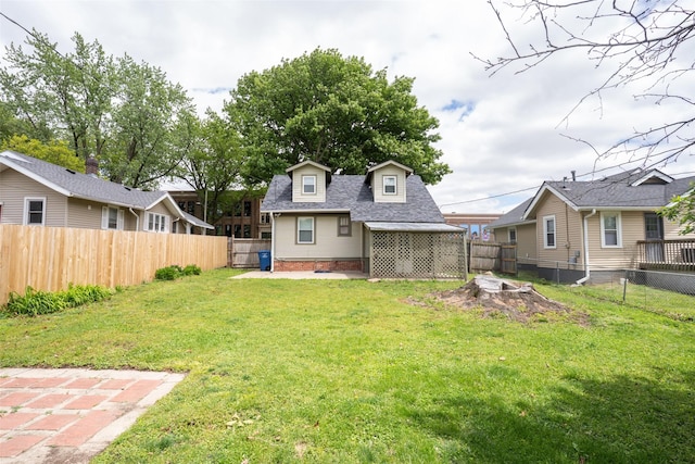 3416 Cambridge St, Des Moines, IA 50313 - rear view of house with roof with shingles and a patio