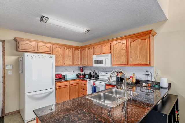 2816 Ashland Ct, Altoona, IA 50009 - kitchen featuring white appliances, a peninsula, tasteful backsplash, and a textured ceiling