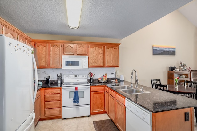 2816 Ashland Ct, Altoona, IA 50009 - kitchen featuring white appliances, a peninsula, lofted ceiling, dark stone countertops, and tasteful backsplash
