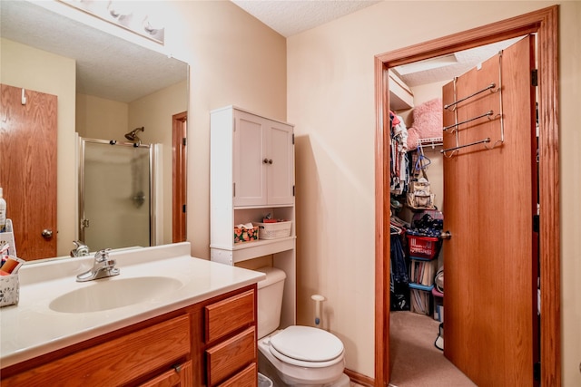2816 Ashland Ct, Altoona, IA 50009 - bathroom with a shower stall, vanity, a textured ceiling, and a spacious closet