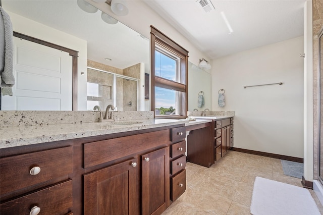 7305 NW 18th St, Ankeny, IA 50023 - bathroom with double vanity, a shower stall, and baseboards