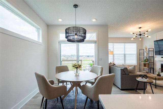 523 NE Vista Ln, Ankeny, IA 50021 - dining room with a chandelier, plenty of natural light, light wood-type flooring, baseboards, and recessed lighting