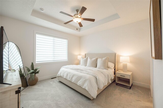 523 NE Vista Ln, Ankeny, IA 50021 - carpeted bedroom with baseboards, a raised ceiling, and a ceiling fan