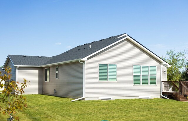 523 NE Vista Ln, Ankeny, IA 50021 - back of property with a yard, a deck, and roof with shingles